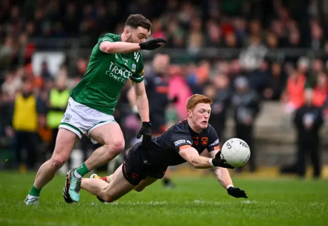 Armagh's Ciaran Mackin gets a touch as Conor McShea closes in