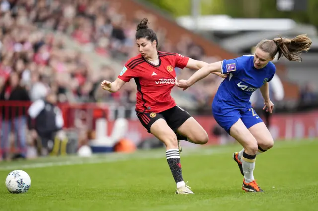 Garcia and Charles duel for the ball