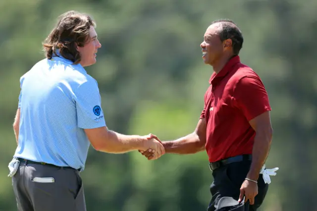 Neal Shipley shakes hands with Tiger Woods at the 2024 Masters