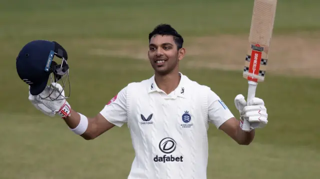 Nathan Fernandes celebrates scoring a century