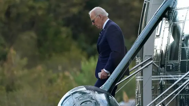 Joe Biden walks down the stairs of a plane