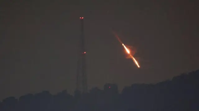 A fireball streaks across the night sky