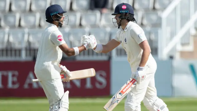 Max Holden and Nathan Fernandes shake hands