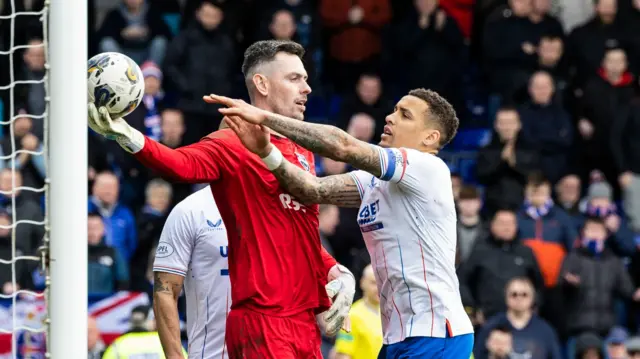 James Tavernier wrestles the ball from Ross Laidlaw after his penalty