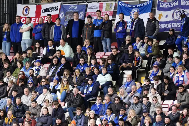 Chelsea fans stand grumpily in the away end