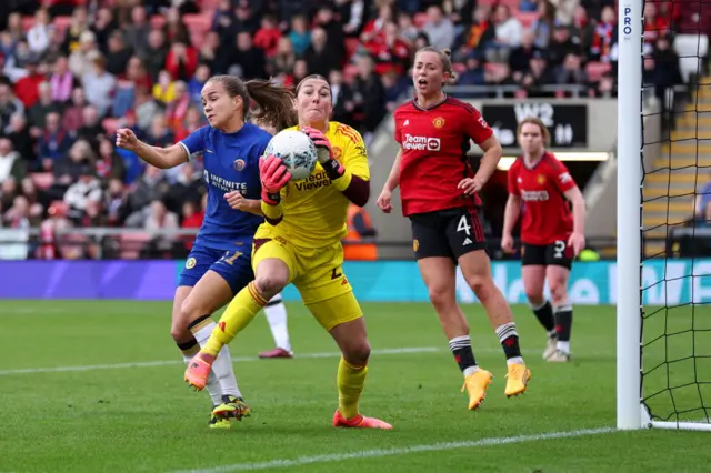 Earps is barged by Reiten as she catches the ball