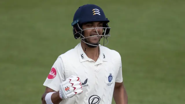 Nathan Fernandes celebrates scoring a century