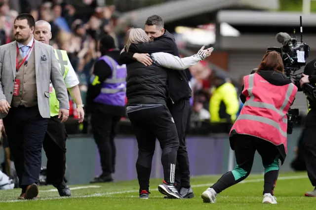 Skinner hugs hus assistant at full time
