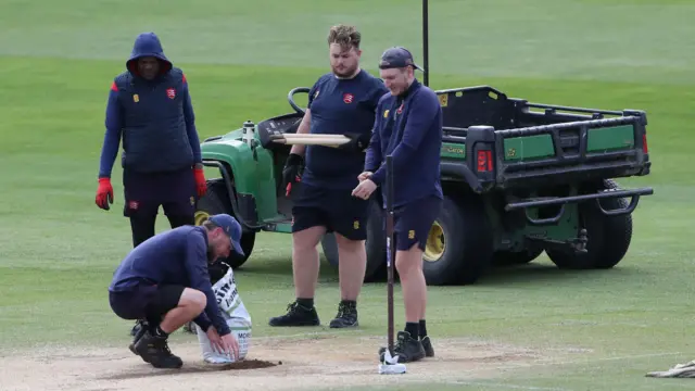 Groundstaff work on the pitch at Essex