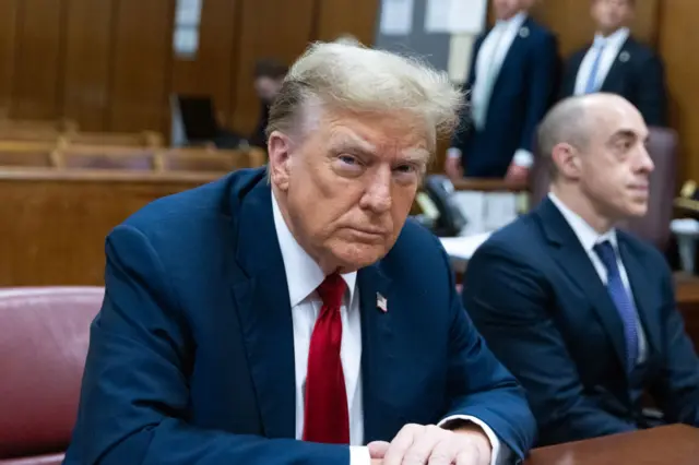 Trump seated in court with his lawyers