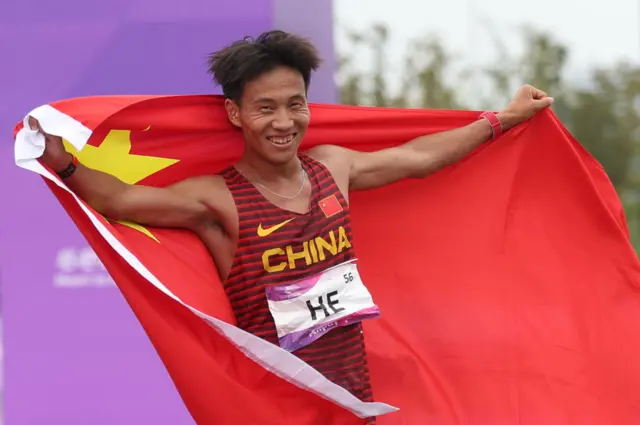 He Jie of Team China celebrates after winning the Athletics - Men's Marathon Final on day 12 of the 19th Asian Games at Smart New World Qiantang River Green Belt on October 5, 2023 in Hangzhou, Zhejiang Province of Team China