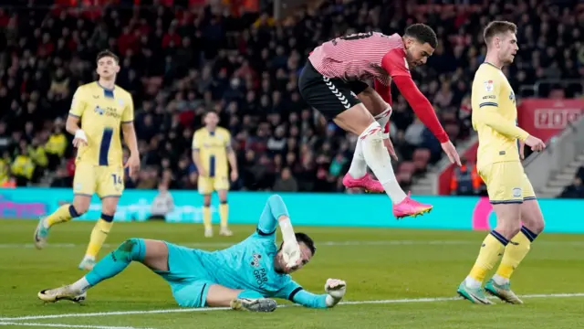 Che Adams jumps after a shot on goal