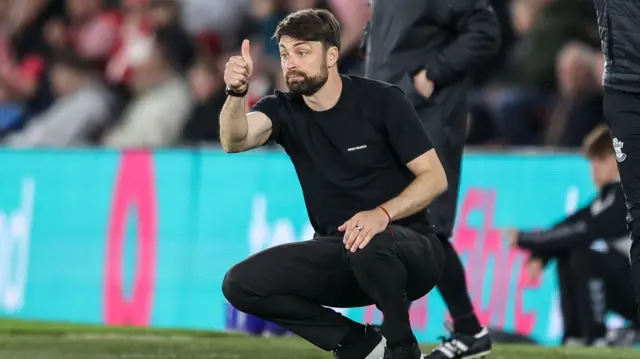 Russell Martin shows a thumbs up from the touchline