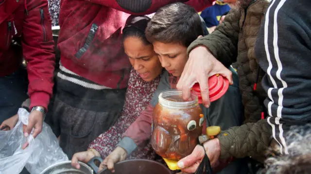 Palestinians receiving food in Jabalia in northern Gaza last month