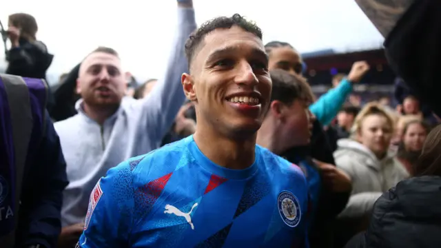 Kyle Knoyle celebrates promotion with Stockport fans