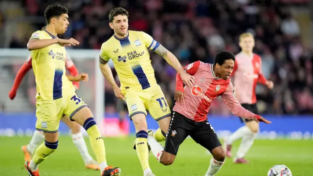 Kyle Walker-Peters goes down under a tackle from Noah Mawene