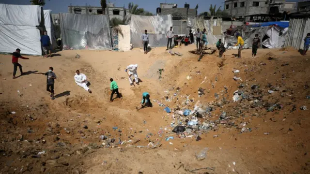 Palestinians in Rafah city dig a pit to bury accumulated rubbish