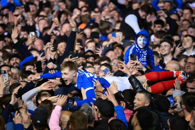 Portsmouth fans and players celebrate their League One title