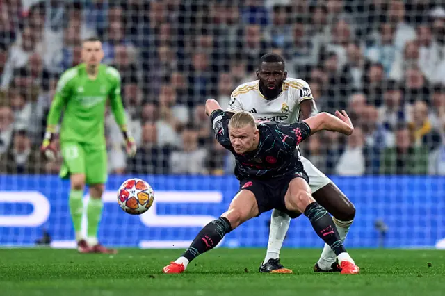 Antonio Rudiger of Real Madrid battle for the ball with Erling Haaland