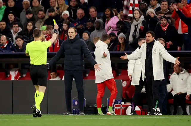 Referee Danny Makkelie shows a yellow card to Zsolt Loew