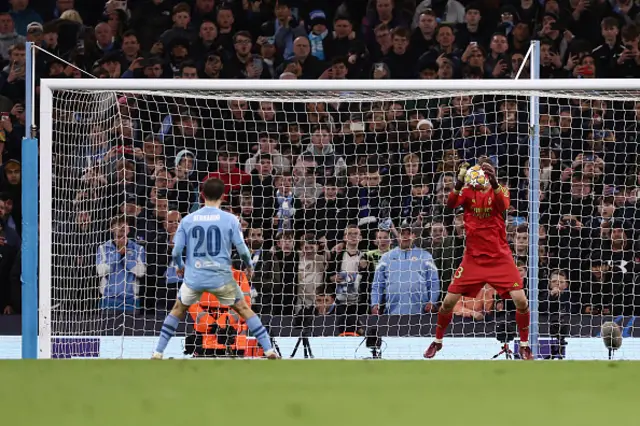 Andriy Lunin of Real Madrid saves the second penalty from Bernardo Silva