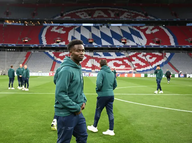 Bukayo Saka looks on, inspecting the pitch at Bayern Munich