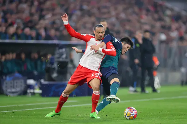 Leroy Sane of Bayern Muenchen and Takehiro Tomiyasu of Arsenal FC battle for the ball