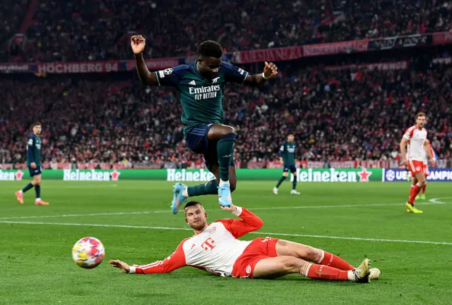 Bukayo Saka of Arsenal is challenged by Eric Dier