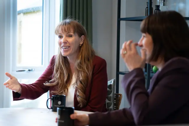 Angela Rayner smiling while talking, with shadow chancellor Rachel Reeves