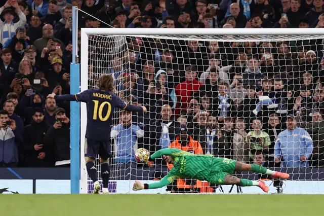 Ederson of Manchester City saves the first penalty from Luka Modric