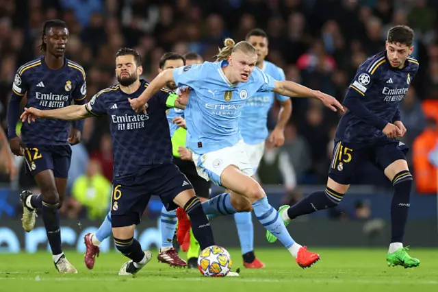 Erling Haaland of Manchester City competes with Nacho Fernandez