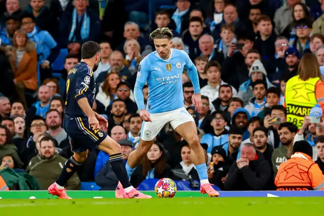 Dani Carvajal marks Jack Grealish of Manchester City who controls the ball