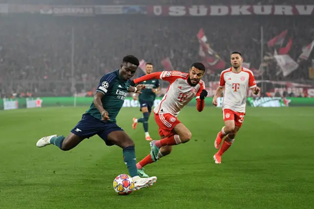 Bukayo Saka of Arsenal runs with the ball whilst under pressure from Noussair Mazraoui