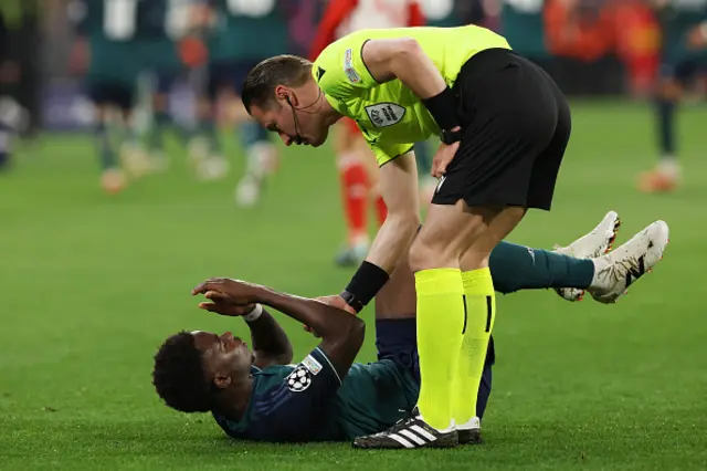 Bukayo Saka lays on the turf