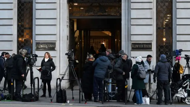 Journalists gather at the entrance of Aldwych House, in London, on January 11, 2024 where the Post Office Horizon IT inquiry takes place