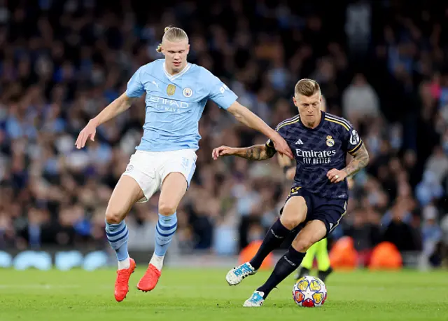 : Toni Kroos of Real Madrid controls the ball whilst under pressure from Erling Haaland