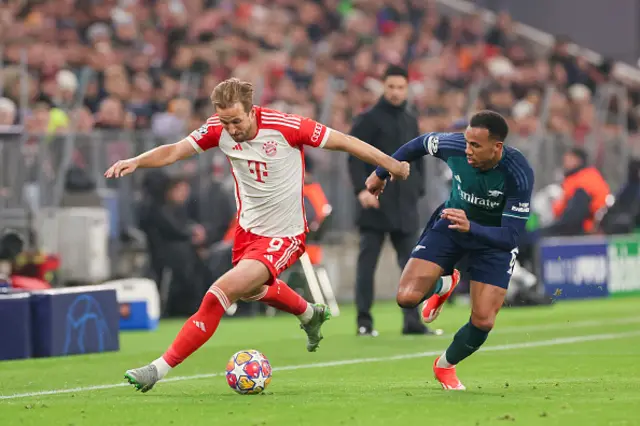 Harry Kane of Bayern Muenchen and Gabriel Magalhaes of Arsenal FC battle for the ball