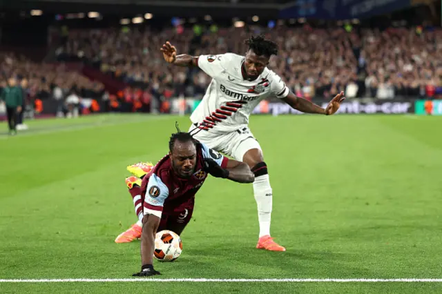 Michail Antonio of West Ham United is challenged by Edmond Tapsoba