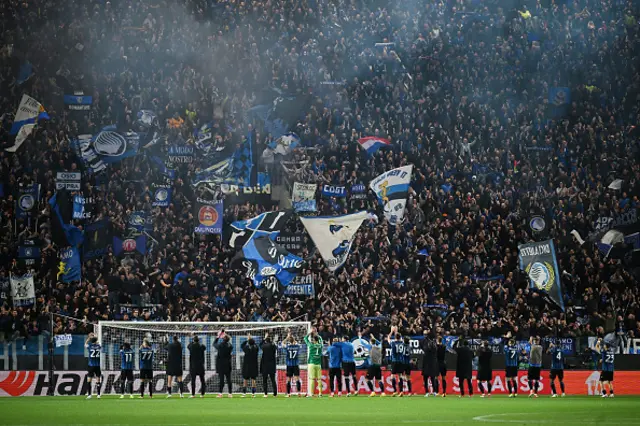 Fans of Atalanta BC celebrate with the players at full-time