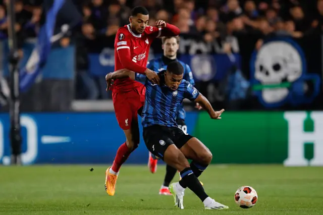 Cody Gakpo of Liverpool challenges Isak Hien