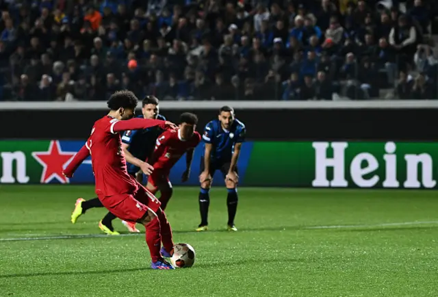 Mohamed Salah shoots and scores a penalty kick