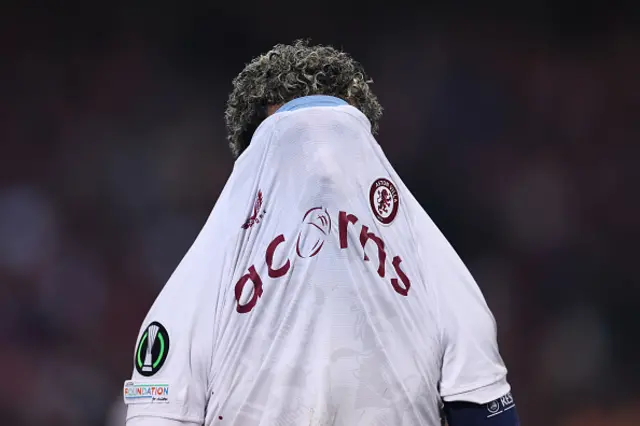 Douglas Luiz covers his face