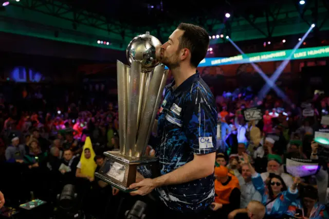 Luke Humphries with World Championship trophy at Alexandra Palace