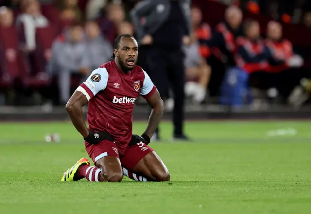 Antonio kneels on the turf