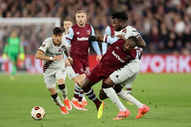 Michail Antonio of West Ham United is challenged by Edmond Tapsoba