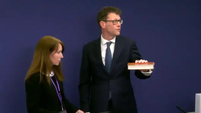 Rodric Williams holds the Bible as he swears an oath