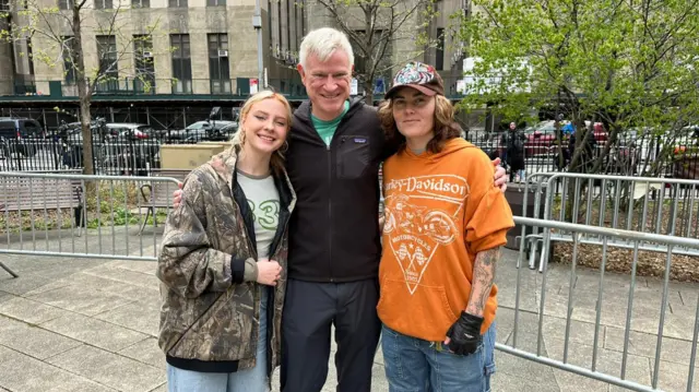 Tourists gather outside the New York courthouse where Donald Trump's trial is taking place