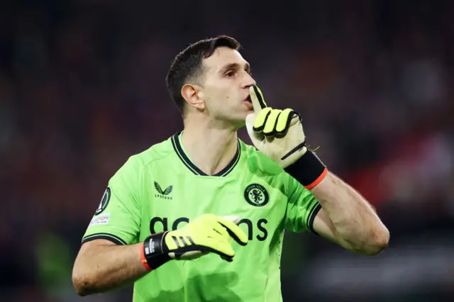 Aston Villa goalkeeper Emiliano Martínez appears to shush the crowd during their penalty shootout win over Lille