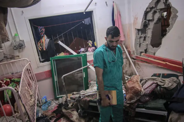 A doctor stands in a destroyed maternity ward in Khan Younis's Nasser hospital in December 2023