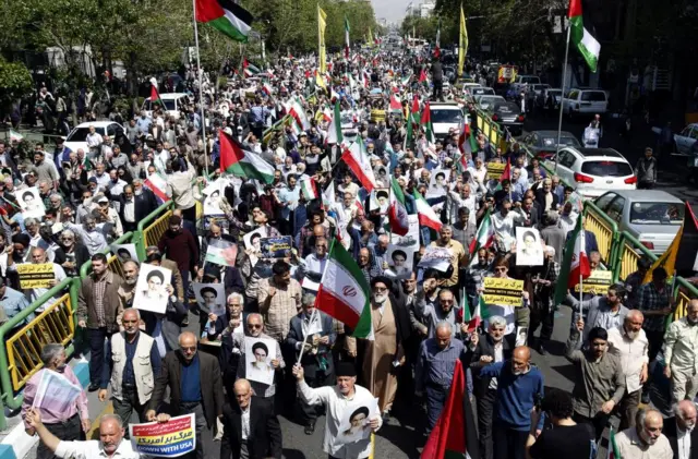 Hundreds of people march at the anti-Israel protest in Tehran.